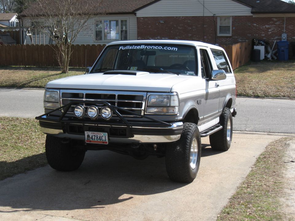 1994 Ford Bronco, white, parked on a driveway, front view, bull bar, off-road tires