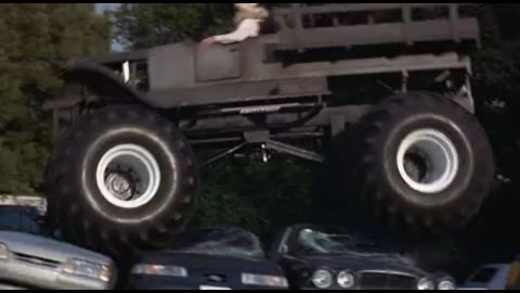 1993 Ford Taurus - A monster truck is shown driving over several cars, with a person visible in the driver's seat.