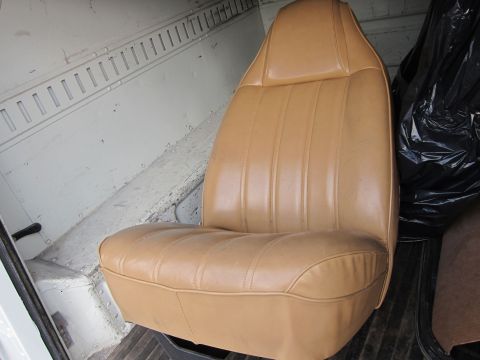 1987 Dodge 1500 - Interior view of a tan vinyl seat with vertical stitching, likely from a cargo van.