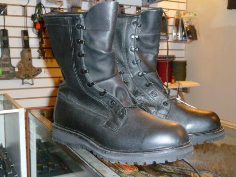 1992 Ford Mustang - Black leather combat boots are displayed for sale in a retail environment.
