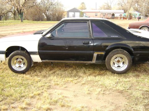 1987 Ford Mustang - Side profile of a 1987 Ford Mustang coupe with two-tone paint.
