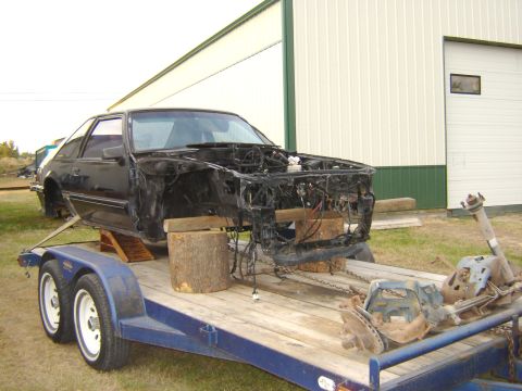 1987 Ford Mustang - This 1987 Ford Mustang is being transported on a trailer, stripped down for project work.