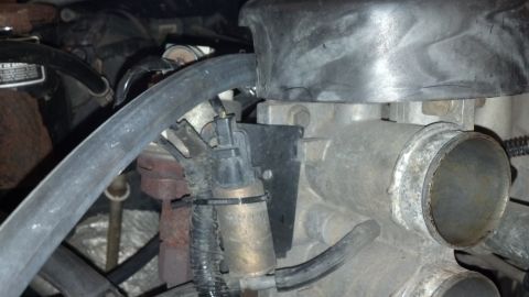 1992 Ford Bronco - This image shows a close-up view of engine components, focusing on hoses and a metallic part.