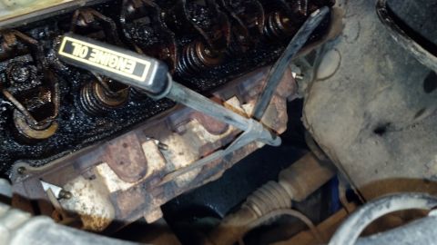 1992 Ford Bronco - Close-up view of an engine's internal components, including the valve train and an oil dipstick.