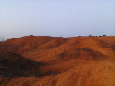 1996 Jeep Cherokee - A vast, undeveloped landscape stretches under a clear sky, with a watermark visible in the lower right corner.