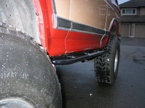 1984 Ford Bronco - Ford Bronco side view showing its body lines and large tires.