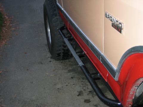 1984 Ford Bronco - Side profile of a 1984 Ford Bronco XLT, its distinctive two-tone paint scheme and aftermarket side steps.