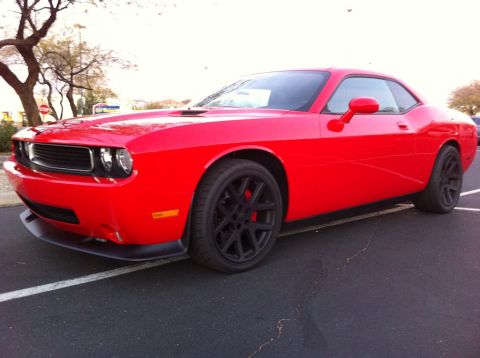2010 Dodge Challenger - Red Dodge Challenger parked in a lot, showing its front 3/4 profile.
