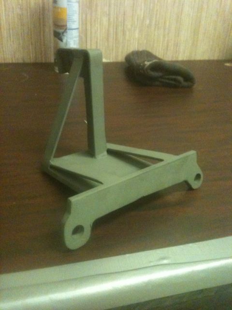 1993 Ford Bronco - A metal bracket is shown on a wooden surface.