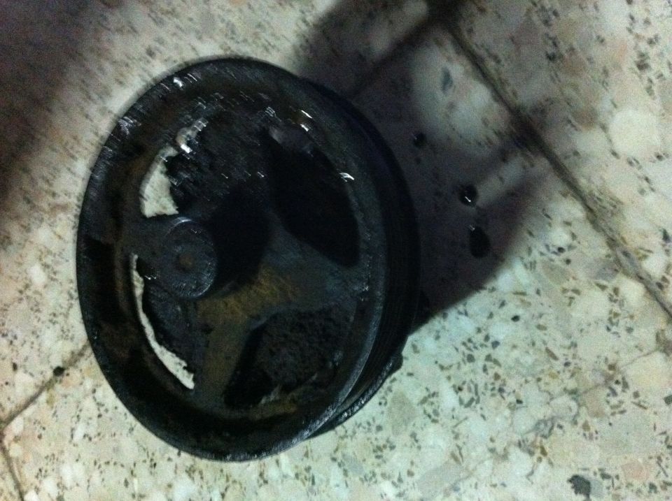 Greasy power steering pump on a tiled floor