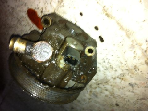 1998 Ford Crown Victoria - A dirty power steering pump shows signs of a fluid leak.