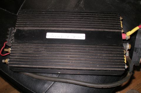 1997 Ford Taurus - A black electronic device with heatsink fins and a handwritten label is shown.