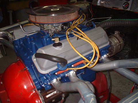 1969 Mercury Cyclone - Close-up view of a V8 engine, showing its blue block, silver valve covers, and exhaust headers.