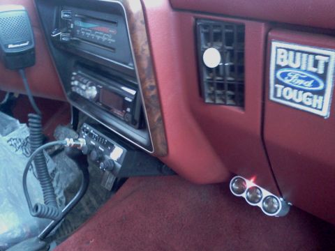 1989 Ford Bronco - Interior view of a vehicle's dashboard, showing aftermarket electronics and a Ford emblem.