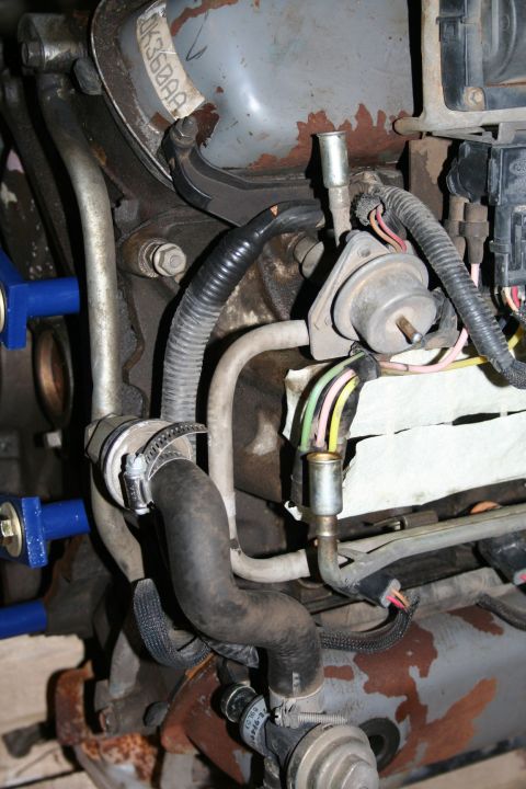 1990 Ford Bronco - Close-up view of various engine parts, including hoses and electrical wiring.