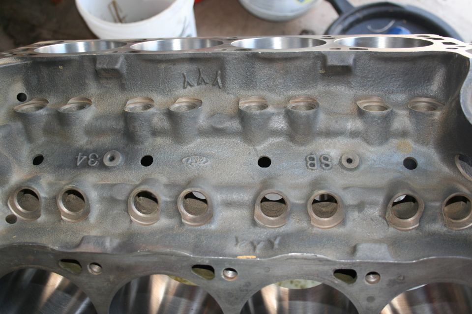 Close-up of an engine block with some numbers and markings cast into it