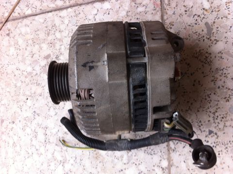 1998 Ford Crown Victoria - This is an alternator, a component of a vehicle's electrical system, shown here with its pulley and wiring.