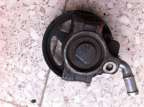 1998 Ford Crown Victoria - Power steering pump with pulley, possibly from a Ford Crown Victoria, but year is not visible.
