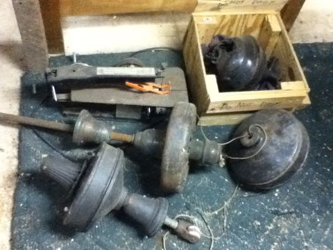 2006 Ford E350 - Several parts of a plumbing snake are visible, along with a wooden crate containing dark, round objects.