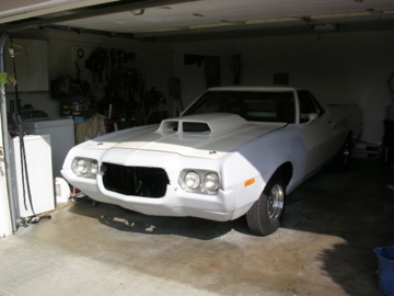 1972 Ford Ranchero - 1972 Ford Ranchero parked inside a garage, showing its front view and a prominent hood scoop.