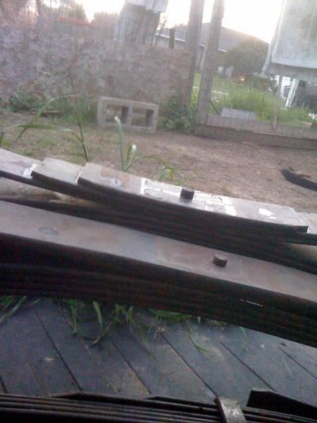 1979 Ford Bronco - Leaf springs are visible in the foreground, with a fence and yard in the background.