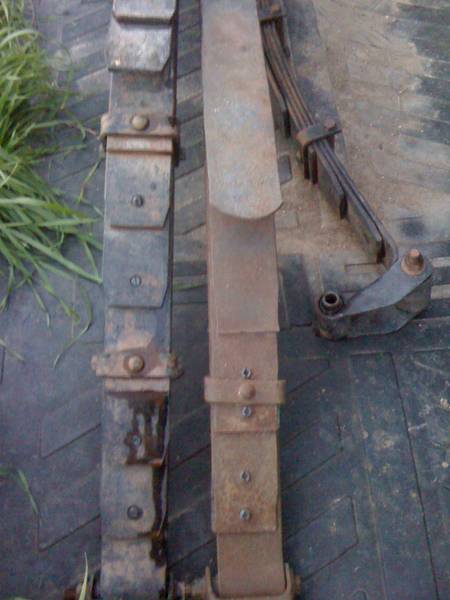 1979 Ford Bronco - These are two leaf springs, likely for a vehicle's suspension system.