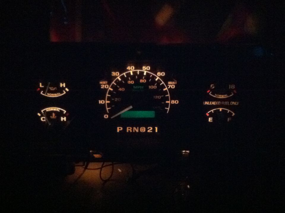 When your done, put it all back together. This is it lit up. Not all of the Bulbs are lit(hooked up to a 9V). If you want a color, you can paint the white with transparent glass paint in any color you want and it will show through. I plan on doing this to my actual cluster, only with white LED's to make them a bright white. This cluster is for sale. ~$45. We can negotiate. PM if interested. It all works, and the PSOM read 286,000mi.