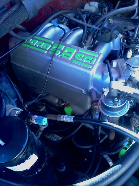1989 Ford Bronco - Close-up view of an engine bay, showing an intake manifold with '5.8 EFI' labeling.