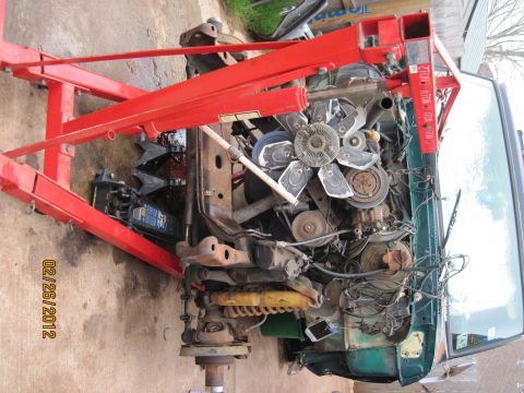 1979 Ford Bronco - Engine removal in progress, captured on February 26, 2012, with a red engine hoist assisting the process.