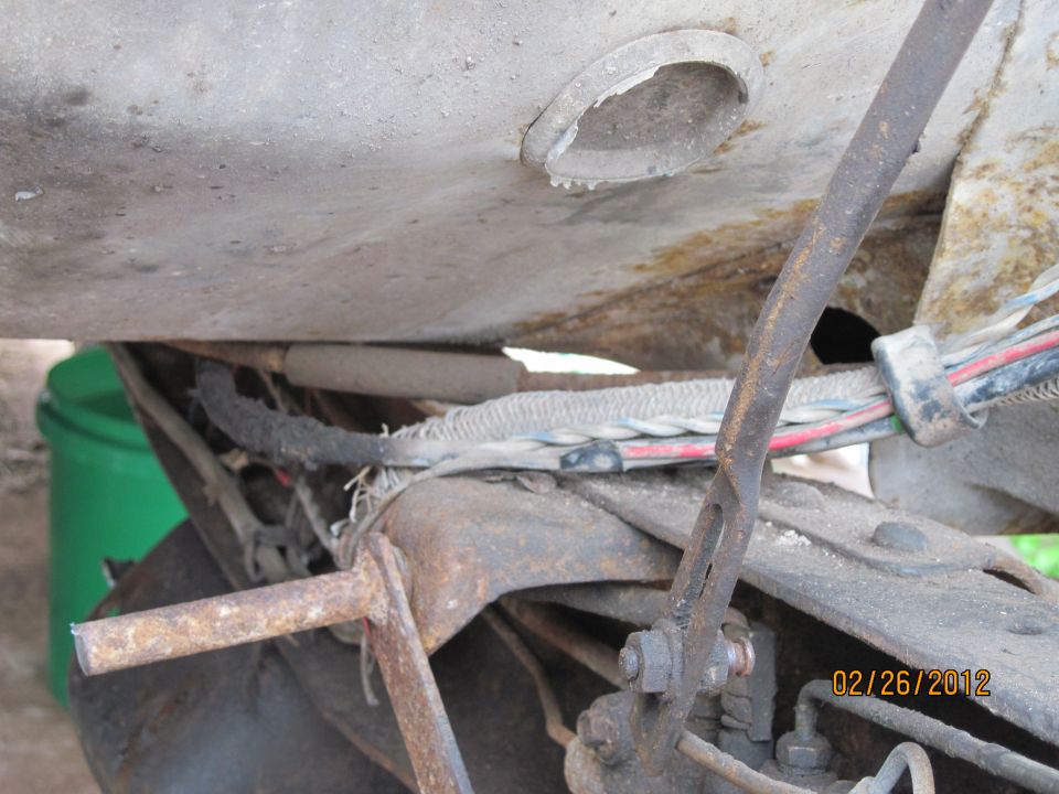 Undercarriage view showing wiring harness and suspension parts. Date stamp reads 02/26/2012