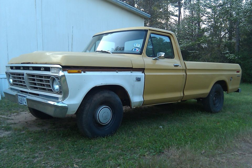 Yellow and white Ford F-100 pickup truck, front quarter view
