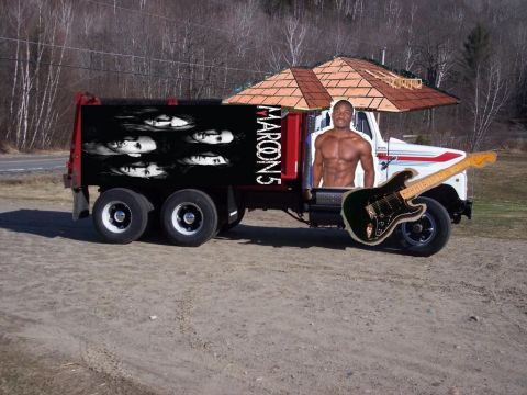 2008 Ford F-250 - A dump truck is decorated with graphics and a guitar, parked on a dirt lot.