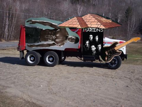 2008 Ford F-250 - Truck decorated with a Maroon 5 ad and a guitar, parked outdoors.