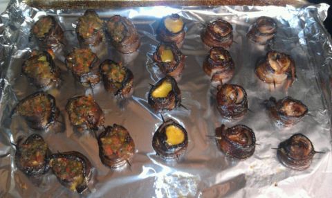 1989 Ford Bronco - Bacon-wrapped appetizers, some stuffed with a colorful filling and others with a yellow cheese, are arranged on a foil-lined baking sheet.
