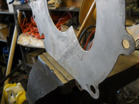 1992 Ford Explorer - A metal bracket is secured in a vise, ready for work. The website "SUPERMOTORS.NET" is visible in the lower right corner.