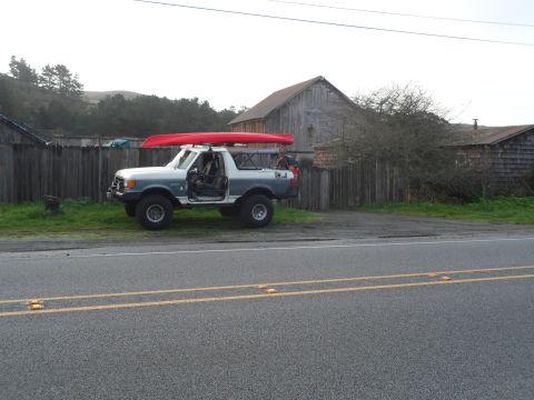 1991 Ford Bronco - This 1991 Ford Bronco is parked by a wooden fence with a red canoe strapped to its roof rack.