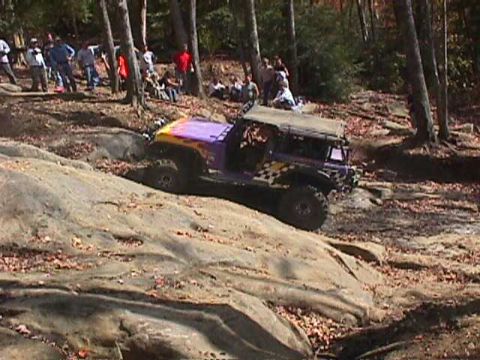 1996 Ford Bronco - An off-road vehicle navigates a challenging rocky terrain during an outdoor event.