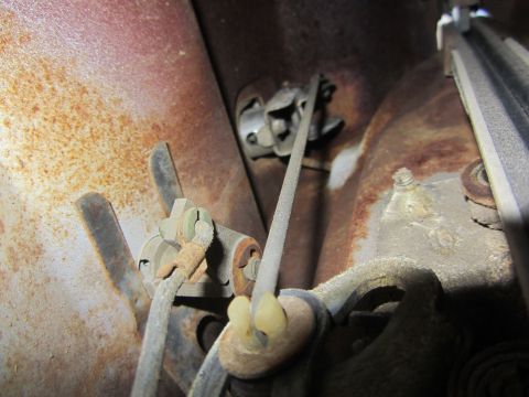1964 Ford Ranchero - Interior door latch mechanism showing cables and mounting hardware, with visible rust.