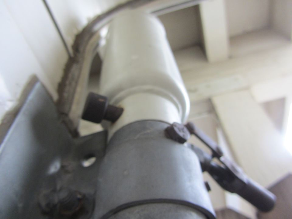 Close-up of a telescoping camper jack leg tube and bracket pinch bolt