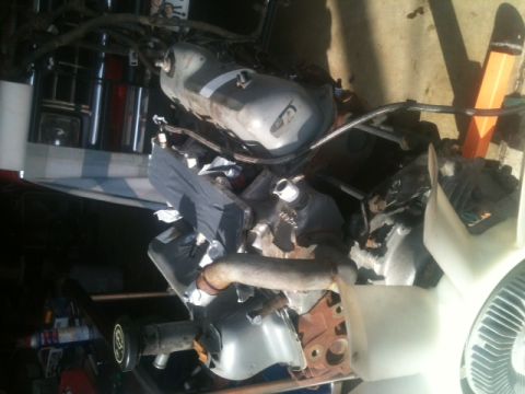 1988 Ford Bronco II - Engine components are visible, including a fuel tank and fan, with some parts covered.