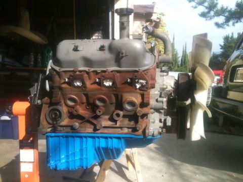 1988 Ford Bronco II - Engine assembly with a blue oil pan sits on a stand, ready for installation or repair.