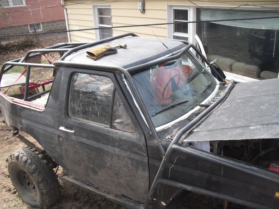 Black off-road SUV with roll cage and exposed interior