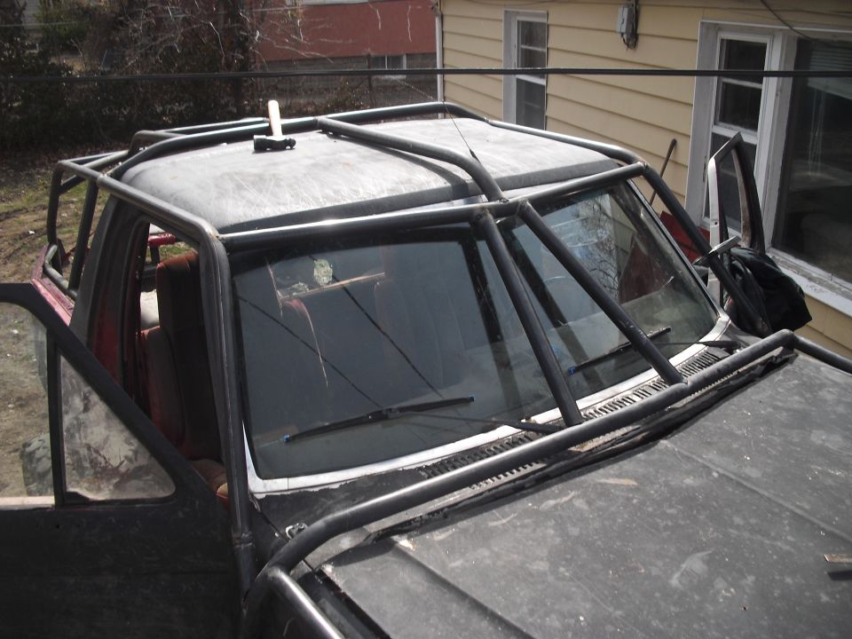 Truck with a full external roll cage and open doors