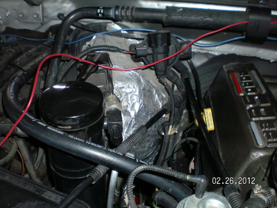 Here I ran the plastic hose "under" the heater hose and you can see where it runs to............