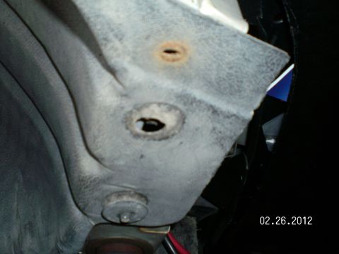 1996 Ford Bronco - This is the front end of the splash shield and is held in by two screws with large washers attached. Once removed you just remove one or tw…