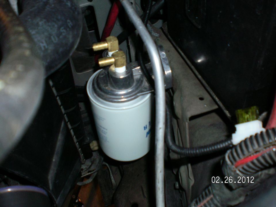 Even though this filter is mounted way up and out of harms way, I can fill the filter with Mercon V and reach in through the engine compartment and spin it on with room to spare and not drip a drop!!!