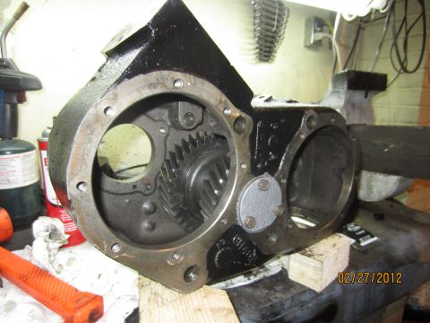 1979 Ford Bronco - Close-up of an NP205 transfer case, showing internal gears and mounting flanges. A date stamp is visible in the lower right corner.