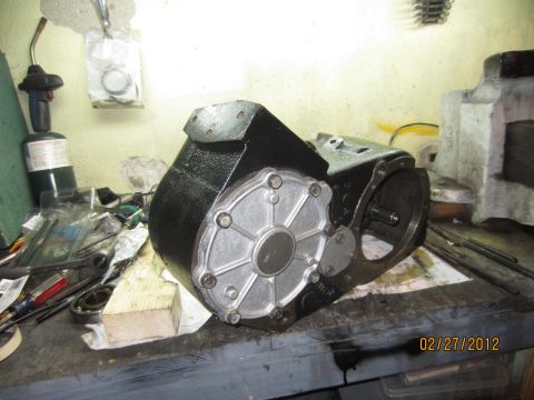 1979 Ford Bronco - An NP205 transfer case sits on a workbench, surrounded by tools and parts, with a date stamp of 02/27/2012.