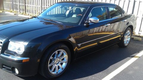1999 Mercury Grand Marquis - A black sedan with chrome accents is parked outdoors, showing its side and front quarter view.
