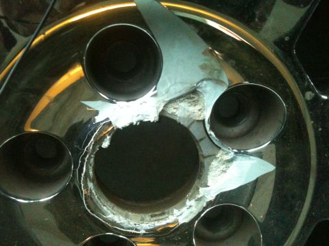 2000 Jeep TJ - Damaged wheel hub with multiple lug nut holes showing wear and tear.
